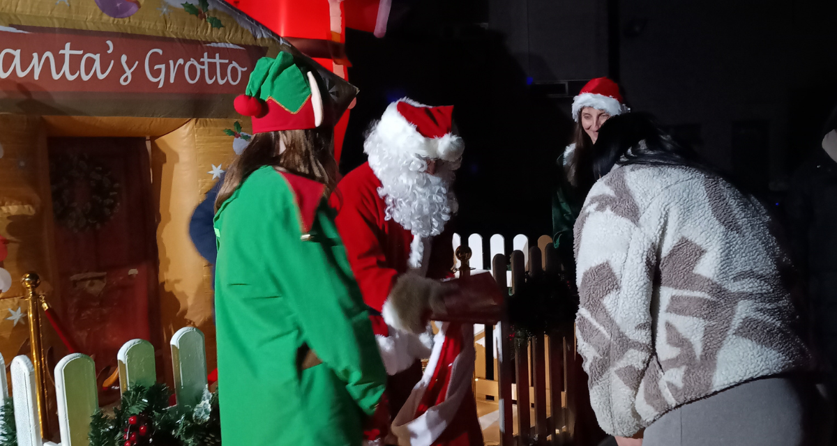 Santa and elves outside grotto